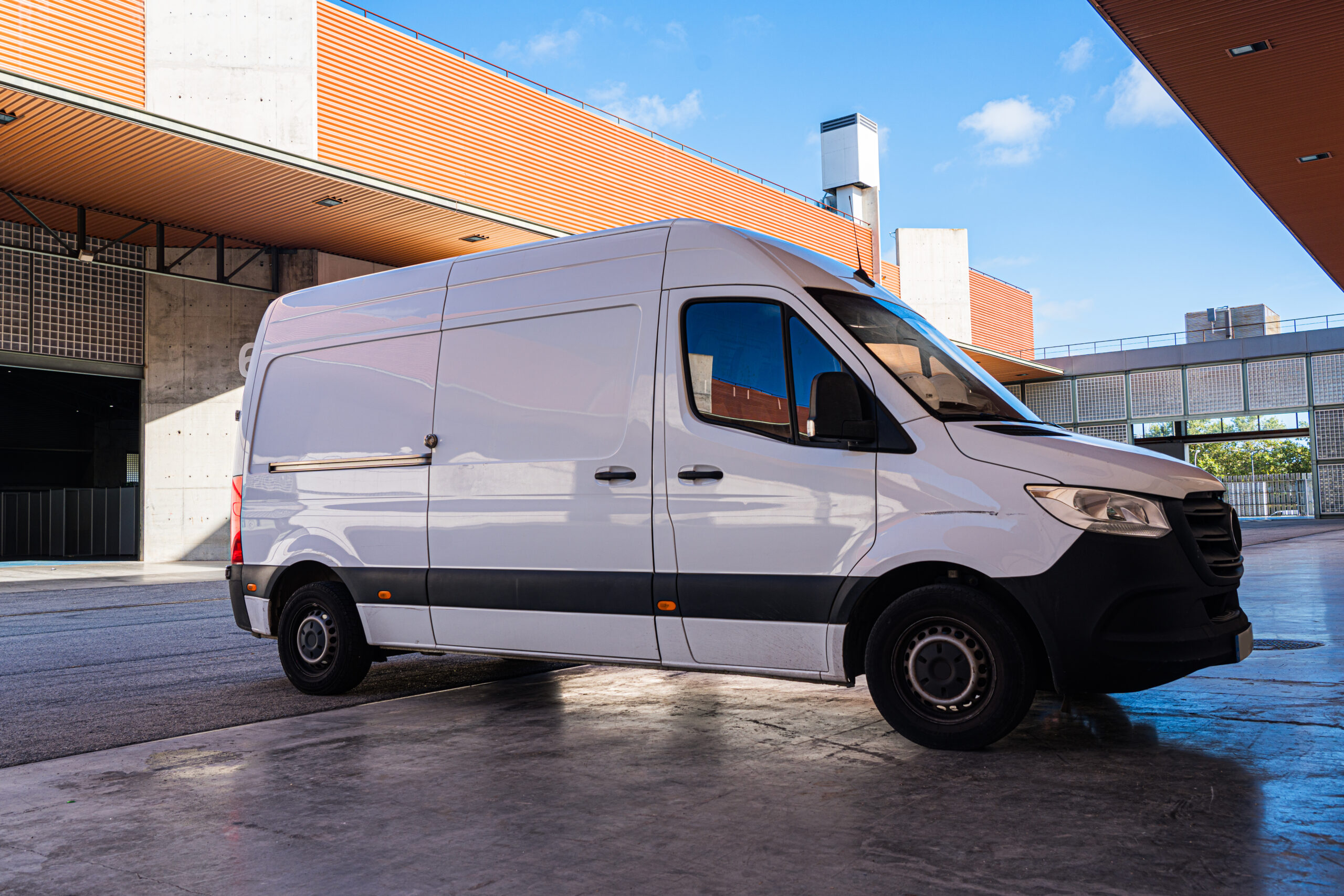 modern-white-cargo-van-parked-industrial-area